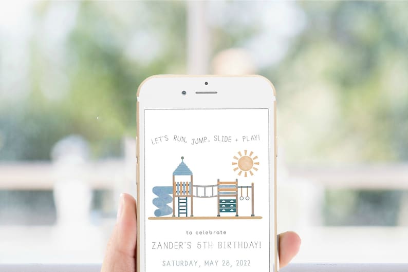 May include: A smartphone displaying a birthday invitation with a cartoon illustration of a playground. The text reads "Let's run, jump, slide, play!" and "Zander's 5th Birthday! Saturday, May 28, 2022".