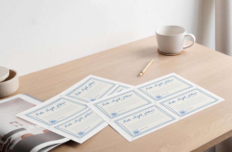 May include: A set of six blank cards with a blue and white border. The cards are labeled "Date Night Ideas" and have lines for writing.
