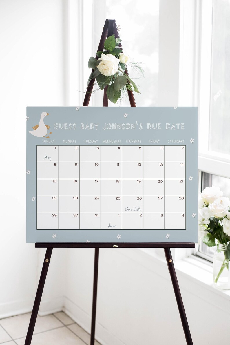 May include: A light blue calendar with white flowers printed on it. The calendar is titled "Guess Baby Johnson's Due Date" and has the month of May with the due date marked on the 26th.
