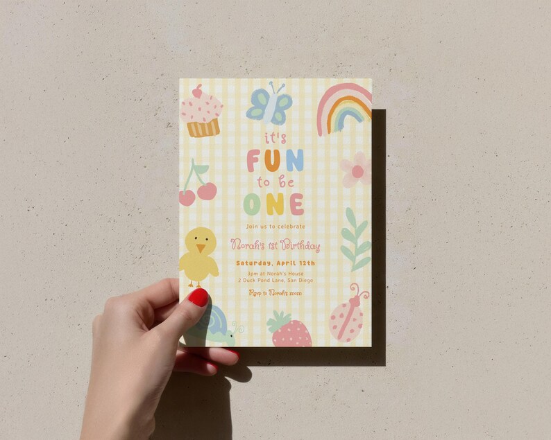 May include: A pastel-colored birthday invitation with a yellow gingham background. The invitation features a cupcake, butterfly, rainbow, flower, cherry, chick, turtle, strawberry, and ladybug illustrations. Text reads "It's Fun to be One" and includes event details.