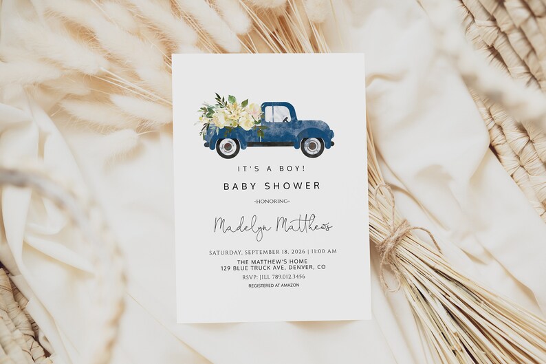 May include: A blue pickup truck with white flowers in the bed. The truck is on a white background with the text "It's a boy! Baby Shower - Honoring Madelga Mattheos" and details for the event.