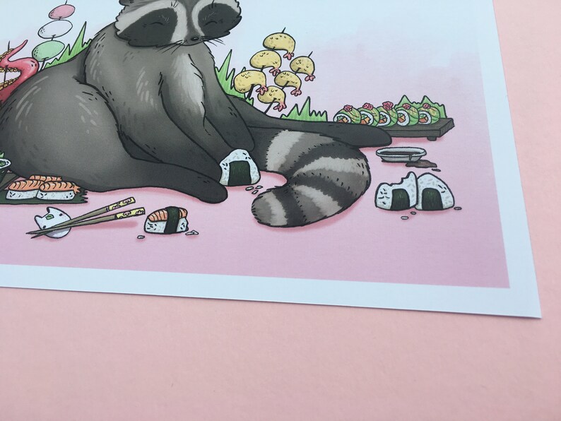 May include: A cartoon raccoon sitting on a pink background with a plate of sushi, chopsticks, and rice balls. The raccoon is wearing a contented expression.