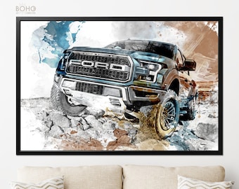 May include: A framed print featuring a Ford Raptor truck navigating a rocky terrain. The artwork has a watercolor effect with blue, brown, and white hues. The word "FORD" is prominently displayed on the truck's grille. The frame is black.