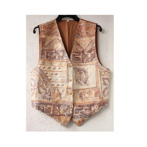 May include: A brown and beige patterned vest with a button closure. The vest has a geometric design with brown and beige accents.