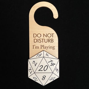 May include: Wooden door hanger with the text "Do Not Disturb I'm Playing" and a 20-sided die.
