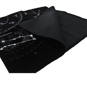May include: Black felt cloth with a white zodiac design. The design includes the constellations Gemini, Cancer, and Leo, as well as a clock face with Roman numerals.