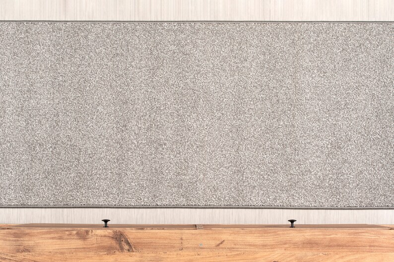 May include: A gray fabric headboard with a wooden frame and two black knobs.