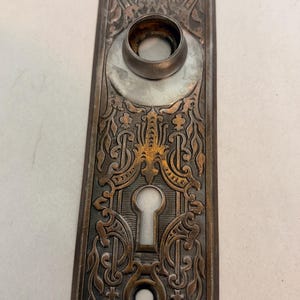 Antique vintage cast iron Victorian Eastlake doorknob keyhole lock backplate