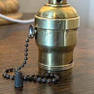 May include: A handmade, wooden cutting board with a natural wood grain. The board features a juice groove and a handle for easy carrying. Dimensions are approximately 18 inches long, 12 inches wide, and 1 inch thick.