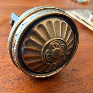 May include: A set of three ceramic mugs with a speckled, matte finish. Each mug features a different color: light blue, cream, and gray. The mugs have a simple, modern design and a comfortable handle.