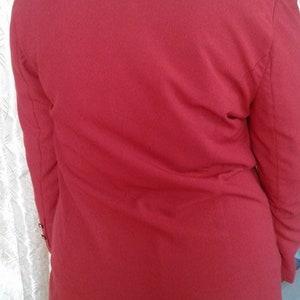 May include: A red blazer with a long sleeve and a collar. The blazer is made of a soft, comfortable fabric.