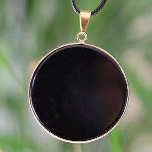 Black mirror Obsidian Natural Stone Disc Shape Pendant.Obsidian Natural Stone Disc Shape Pendant, often referred to as a black mirror image 1