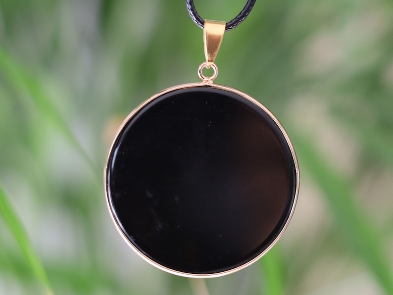 Black mirror Obsidian Natural Stone Disc Shape Pendant.Obsidian Natural Stone Disc Shape Pendant, often referred to as a black mirror image 1