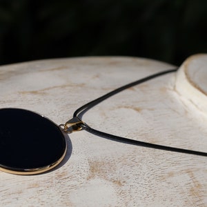 Black mirror Obsidian Natural Stone Disc Shape Pendant.Obsidian Natural Stone Disc Shape Pendant, often referred to as a black mirror image 4