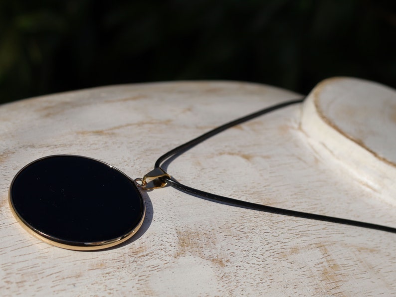 Black mirror Obsidian Natural Stone Disc Shape Pendant.Obsidian Natural Stone Disc Shape Pendant, often referred to as a black mirror image 4