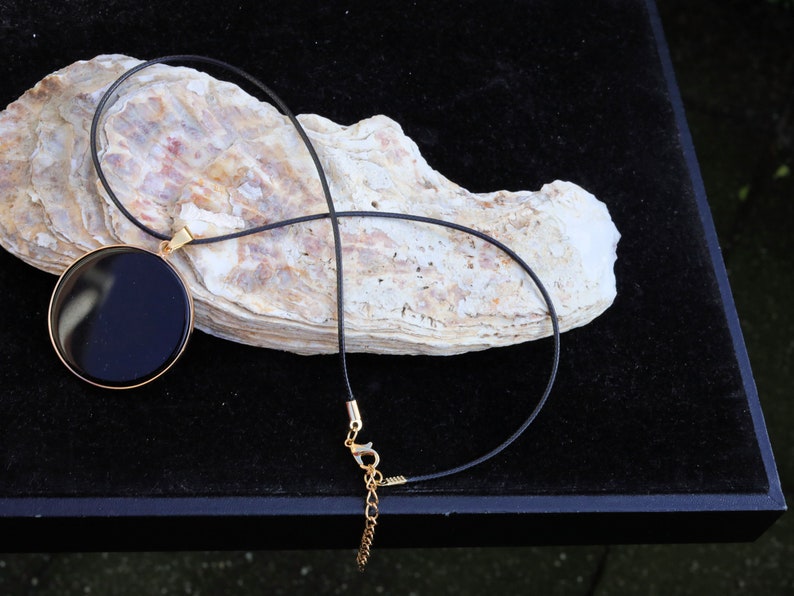 Black mirror Obsidian Natural Stone Disc Shape Pendant.Obsidian Natural Stone Disc Shape Pendant, often referred to as a black mirror image 2