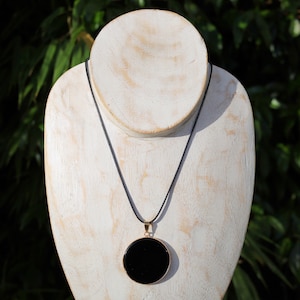 Black mirror Obsidian Natural Stone Disc Shape Pendant.Obsidian Natural Stone Disc Shape Pendant, often referred to as a black mirror image 3