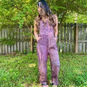 May include: A white ceramic mug with a black handle and the text "But First, Coffee" in a black, handwritten-style font. The mug is on a white surface.