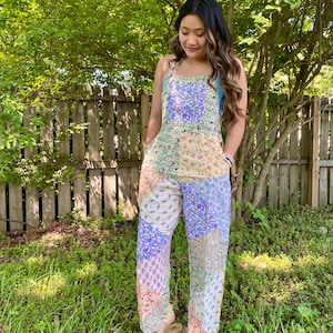 May include: A white ceramic mug with a black handle and the text "But First, Coffee" in a black, handwritten-style font. The mug is on a white surface.