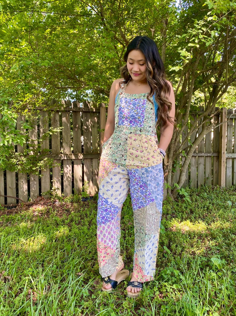 May include: A white ceramic mug with a black handle and the text "But First, Coffee" in a black, handwritten-style font. The mug is on a white surface.