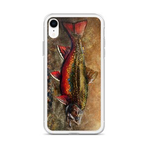 May include: A phone case with a colorful illustration of a trout fish on a brown background.