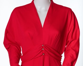 May include: A long-sleeved red dress with a V-neckline and a cinched waist. The dress has a series of small buttons down the front.