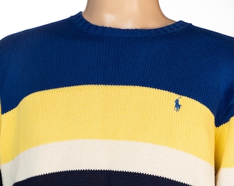 May include: A blue, yellow, white, and navy blue striped sweater with a small embroidered polo player logo on the chest.
