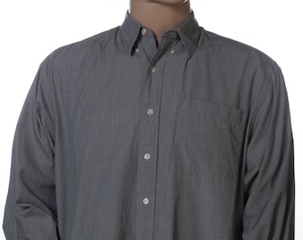 May include: A long-sleeved, gray button-down shirt with a pocket on the left side.