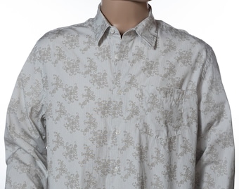 May include: A white long-sleeve button-down shirt with a brown floral pattern and thin vertical stripes.