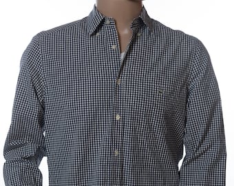 May include: A long-sleeved button-down shirt with a navy and white checkered pattern. The shirt has a classic collar, a chest pocket, and buttoned cuffs. The mannequin is also wearing blue underwear.