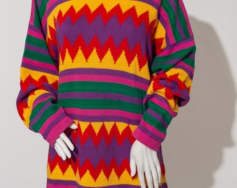 May include: A colorful striped sweater with a geometric pattern in shades of red, yellow, green, purple, and pink.