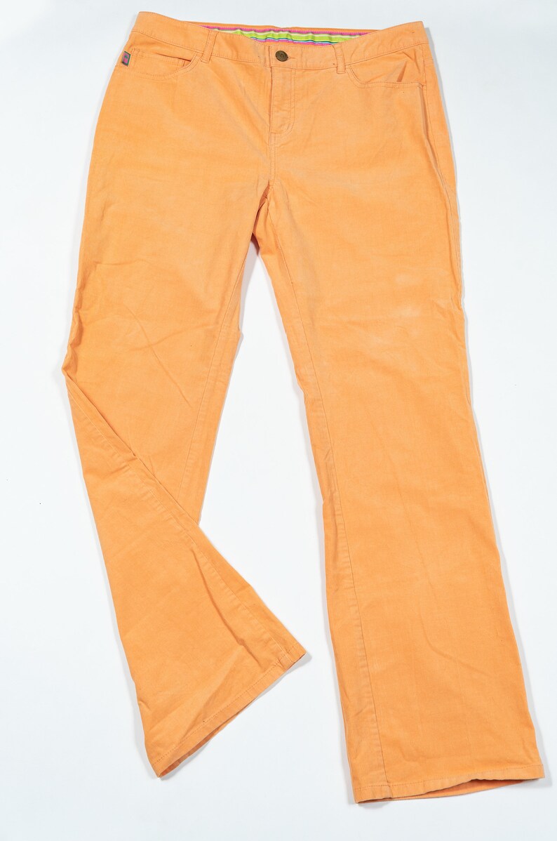 May include: A pair of orange corduroy pants with a straight leg fit.