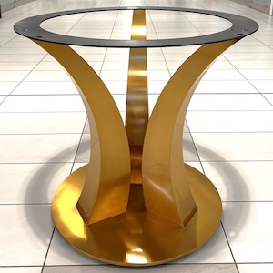 May include: A modern table base with a gold finish. The base features a circular bottom, curved legs, and a black ring at the top for attaching a tabletop. The design is sleek and contemporary, suitable for various interior styles.