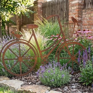 A rust-colored metal bicycle sculpture is surrounded by a lush garden filled with purple flowers and greenery.