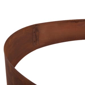 a curved, brown metal surface with a small, rusty metal piece attached to it.