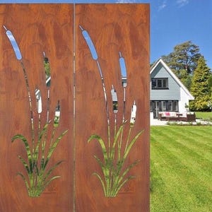 a rust-colored metal fence with a design of reeds or grasses on it, set against a backdrop of a well-maintained lawn and a house surrounded by trees.