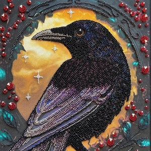 May include: A beaded artwork depicting a black raven with iridescent purple and blue feathers, perched on a branch with red berries. The raven is set against a background of a golden moon with stars.