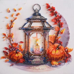 May include: A beaded artwork featuring a lantern with a lit candle inside, surrounded by autumn leaves and a pumpkin. The lantern is made of dark blue and brown beads, with a silver handle. The candle is pink and white, and the leaves are red, orange, and yellow. The pumpkin is orange and has a green stem.