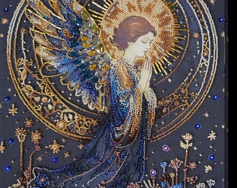 May include: A beaded artwork depicting an angel with wings, a halo, and a crown. The angel is surrounded by a circle of stars and a crescent moon. The background is a dark blue with gold accents.