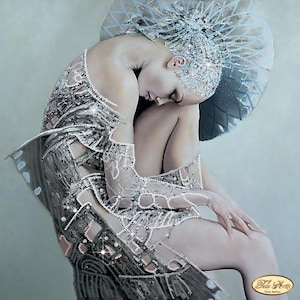 May include: A detailed image of a person wearing an elaborate silver and pearl embellished gown and headpiece. The gown features intricate patterns and sparkling accents. The person is seated, with their head bowed, creating a serene and artistic composition.