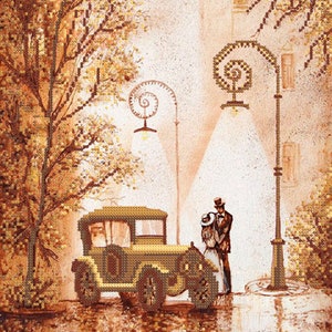 May include: A vintage car parked on a street with a couple standing next to it. The car is green and has a brown roof. The couple is dressed in vintage clothing. The street is lined with trees and there are streetlights in the background.