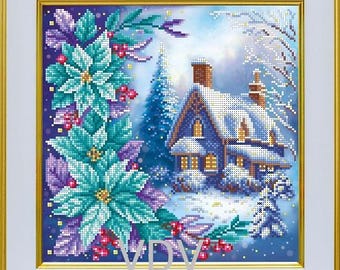 May include: A framed cross-stitch embroidery depicting a winter scene with a snow-covered house, a tall evergreen tree, and large teal poinsettia flowers with red berries in the foreground. The letters VDV are printed in the lower center area.