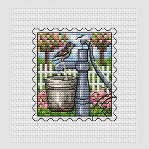 May include: A vintage-style illustration of a well pump with a bucket and a bird perched on the handle. The pump is surrounded by a green border with pink flowers and a white picket fence.