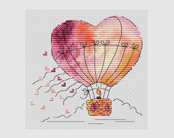 Könnte beinhalten: Ein herzförmiger Heißluftballon mit rosa, orange und gelben Aquarellmustern. Der Ballon ist an einem Korb befestigt, aus dem eine Flamme herausragt. Kleine rosa Herzen sind um den Ballon herum verstreut.
