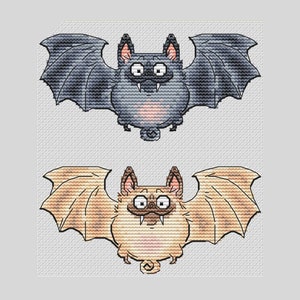 May include: Two cartoon bats with large eyes and fangs. The bat on top is gray with black wings, and the bat on the bottom is brown with tan wings.