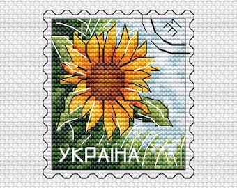 Puede incluir: Un sello postal de estilo vintage con un girasol y la palabra "UKRAINE" impresa en verde.