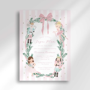 Puede incluir: Invitación a un baby shower con un fondo a rayas rosas y blancas. La invitación presenta una corona de vegetación e ilustraciones de cascanueces y bailarinas. El texto dice "Our Little Sugar Plum is on the way."