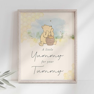 May include: A Winnie the Pooh themed nursery print with a watercolor background. The print features Winnie the Pooh holding a honey pot with the text "A little Yummy for your Tummy".
