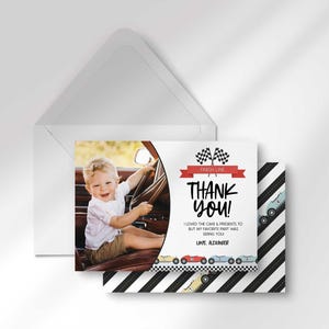 Alexander's race car-themed thank you photo card layered in front of its matching envelope, with the black and white diagonal race-stripe back design peeking out behind it.