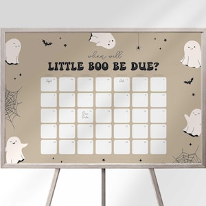 May include: A Halloween-themed calendar with the text "When will LITTLE BOO BE DUE?" in a playful font. The beige background features ghost illustrations, bats, spiderwebs, and stars. The calendar grid is designed for marking dates.